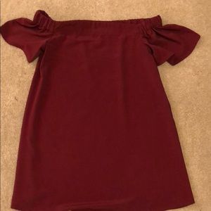 A maroon/burgundy off the shoulder dress.